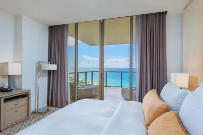 a bedroom with a bed and a view of the ocean at 3MM Oceanfront Residence at Finest Bal Harbour Resort - Hotel Amenities in Miami Beach