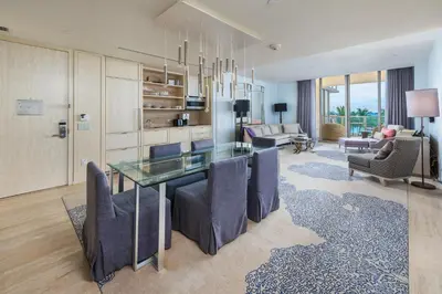 a living room with a glass table and chairs at 3MM Oceanfront Residence at Finest Bal Harbour Resort - Hotel Amenities in Miami Beach