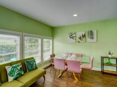 a dining room with a table and pink chairs at Luxury Miami Casa Bonita with Tropical Pool Oasis in Miami