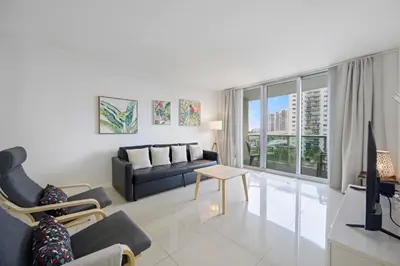 a living room with a couch and a table at Beautiful and big Apartment by the beach in Sunny Isles Beach