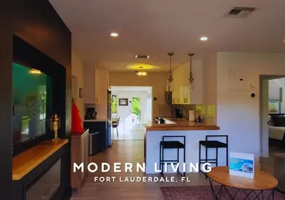 a kitchen and living room with a table in it at Private Heated Plunge Pool Spa and Secluded Patio - Fort Lauderdale in Fort Lauderdale