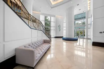 a living room with a couch and a staircase at FountaineBleau Resort, Balcony with Ocean & Pool View in Miami Beach