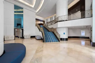 a spiral staircase in a building with blue steps at FountaineBleau Resort, Balcony with Ocean & Pool View in Miami Beach