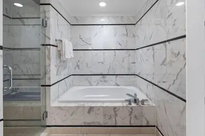 a bathroom with a bath tub and a sink at FountaineBleau Resort, Balcony with Ocean & Pool View in Miami Beach
