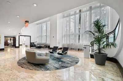 a lobby with chairs and a table in a building at FountaineBleau Resort, Balcony with Ocean & Pool View in Miami Beach