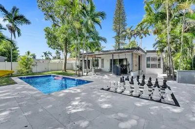 a backyard with a chess board and a pool at Private Waterfront Paradise in Hollywood