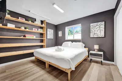 a bedroom with a large white bed and shelves at Private Waterfront Paradise in Hollywood