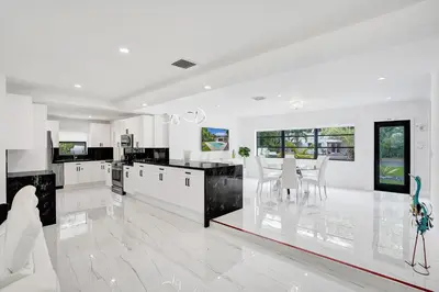 a large white kitchen with white counters and white appliances at Hibiscus House in Fort Lauderdale