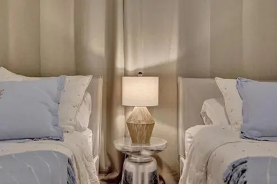 a bedroom with two beds and a table with a lamp at Le Petit Italie ,water View 22 With Pool in Sunny Isles Beach