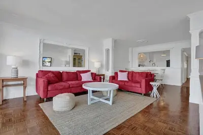 a living room with two red couches and a table at Le Petit Italie ,water View 22 With Pool in Sunny Isles Beach