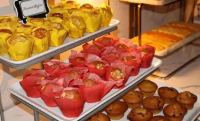 three trays of food on display in a bakery at Hotel Downtown Miami - DQR in Miami