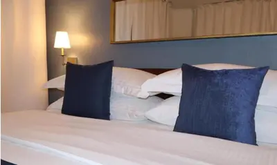a hotel room with two beds with blue and white pillows at Hotel Downtown Miami - DQR in Miami