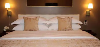 a large white bed with two pillows on it at Hotel Downtown Miami - DQR in Miami