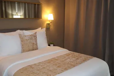 a bedroom with a large bed with white sheets at Hotel TB Downtown Miami in Miami