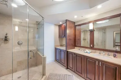 a bathroom with two sinks and a shower at Modern 2 BDR at King David with Ocean View in Sunny Isles Beach