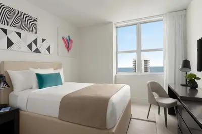 a bedroom with a bed and a desk and a window at Hyde Beach by Zelloo in Hollywood