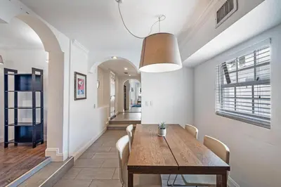 a dining room with a wooden table and chairs at West Brickell GEM With Private Garden, 2BR 2BATH in Miami