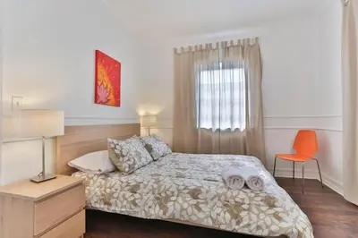 a bedroom with a bed and a orange chair at 3 Bedroom Apartment with BBQ and Patio, Near Brickell in Miami