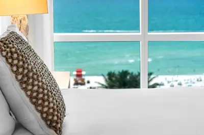 a couch with a view of the beach from a window at Oceanview Private Condo at 1 Hotel & Homes -1222 in Miami Beach