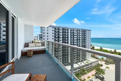 a balcony with a bed and a view of the ocean at Oceanview Private Condo at 1 Hotel & Homes -1222 in Miami Beach