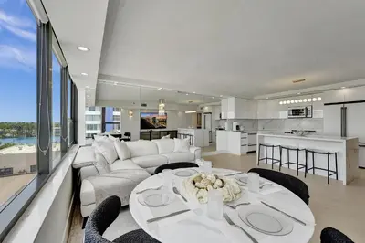a living room with a white couch and a table at Beautiful Oceanfront 3BDR Condo 801 in Miami Beach