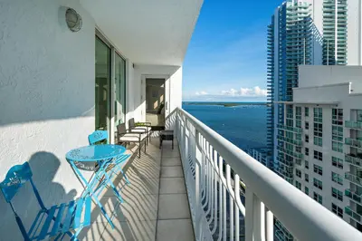 a balcony with a view of the ocean on a building at Stylish 2BR With Skyline Views, Free Parking, Sleeps 8 in Miami