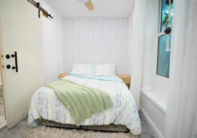 a bedroom with a bed with a green blanket at Cozy Tiny Home - Hidden Gem! in Miami