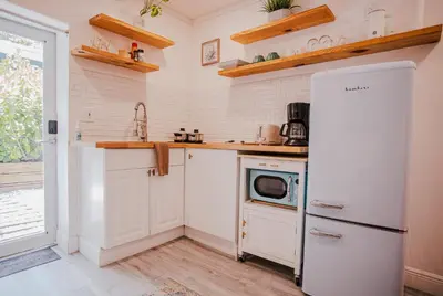 a kitchen with a white refrigerator and a microwave at Cozy Tiny Home - Hidden Gem! in Miami