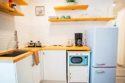 a kitchen with a refrigerator and a washing machine at Cozy Tiny Home - Hidden Gem! in Miami