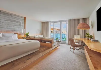 a hotel room with a bed and a desk and a desk at 1 Hotel South Beach in Miami Beach