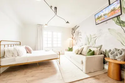 a living room with a couch and a tv at Amazing studio in Ocean Drive in Miami Beach