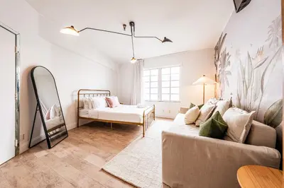 a living room with a couch and a bed at Amazing studio in Ocean Drive in Miami Beach