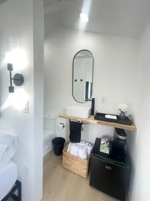 a bathroom with a sink and a mirror on a wall at Charming Coastal Retreat in Miami