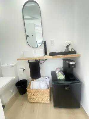 a bathroom with a sink and a mirror at Charming Coastal Retreat in Miami