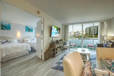 a bedroom with a bed and a living room at GalleryOne Doubletree Hilton GC Turtle Cove in Fort Lauderdale