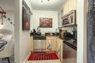 a kitchen with a red rug on the floor at GalleryOne Doubletree Hilton GC Turtle Cove in Fort Lauderdale