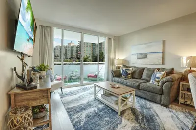 a living room with a couch and a large window at GalleryOne Doubletree Hilton GC Turtle Cove in Fort Lauderdale