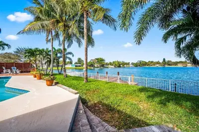 a view of a body of water with palm trees at Inactive 193 Modern, 4B&3B with Pool and Lake in Pembroke Pines