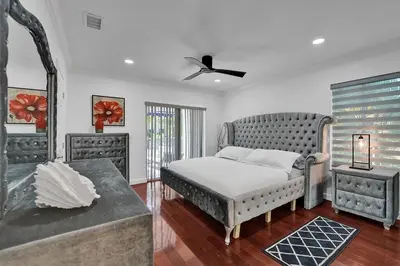 a bedroom with a bed and a tub in it at Beautiful Tropical Vacation House close to Beach in Hollywood