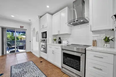 a white kitchen with a sink and a stove at Beautiful Tropical Vacation House close to Beach in Hollywood