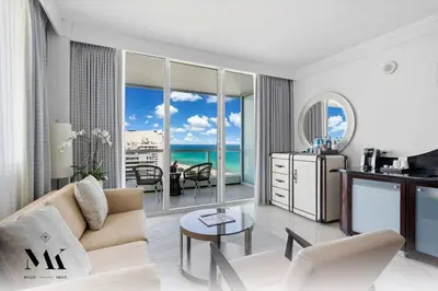 a white living room with a view of the ocean at FontaineBleau, Balcony w Ocean plus Bay and City View in Miami Beach