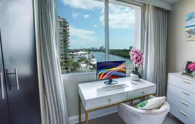 a desk with a computer and a window at GalleryOne Doubletree Hilton GC Secret Blending in Fort Lauderdale