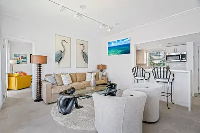 a living room with a couch and a table and chairs at Walk to Ft Lauderdale beach - Water Views & Pool in Fort Lauderdale