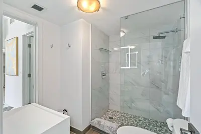 a bathroom with a shower with a glass door at Walk to Ft Lauderdale beach - Water Views & Pool in Fort Lauderdale