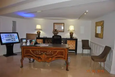 an office with a desk with a computer and chairs at Luxury Beachfront 3 Bedroom Miami Beach Condo, in Miami Beach