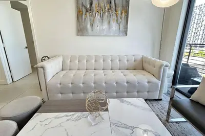 a living room with a white couch and a table at Resort Style Luxury Living in Doral, Miami in Miami