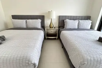 two beds sitting next to each other in a bedroom at Resort Style Luxury Living in Doral, Miami in Miami