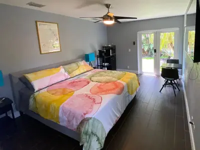 a bedroom with a bed and a ceiling fan at Riverbank Guesthouse Wilton Manors in Fort Lauderdale