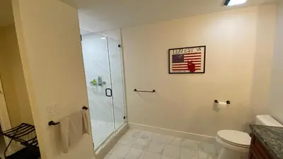 a bathroom with a shower with an american flag on the wall at Riverbank Guesthouse Wilton Manors in Fort Lauderdale