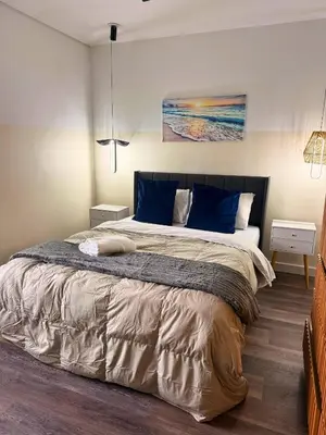 a bedroom with a large bed with blue pillows at Luxury RiverFront By Renzzi in Miami